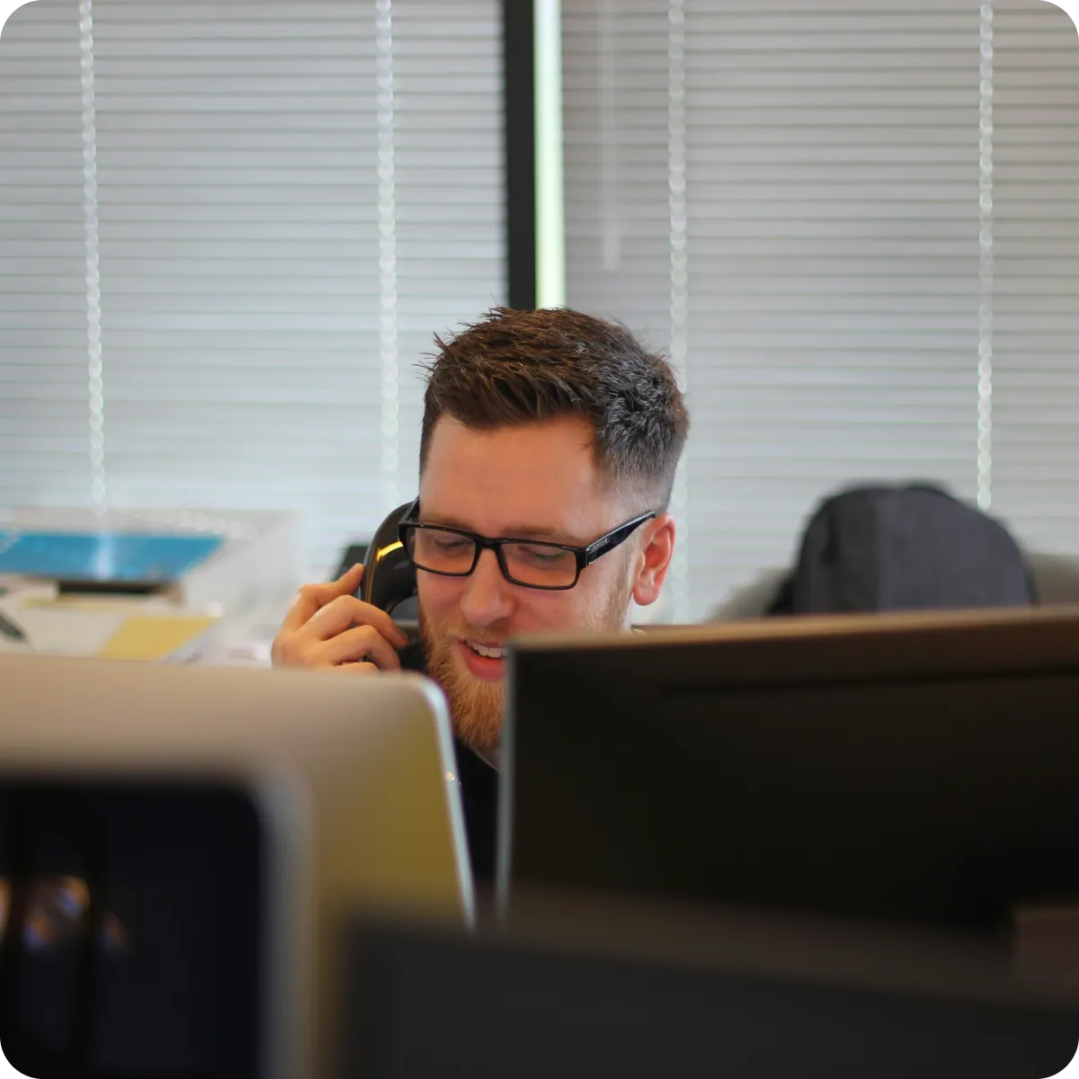 A Cirrus support technician taking a call at the support desk