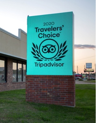 A cirrus led sign showing that this business was the 2020 Traveler's Choice for Trip Advisor,  it shows a pro of digital signage to show wins for your business.