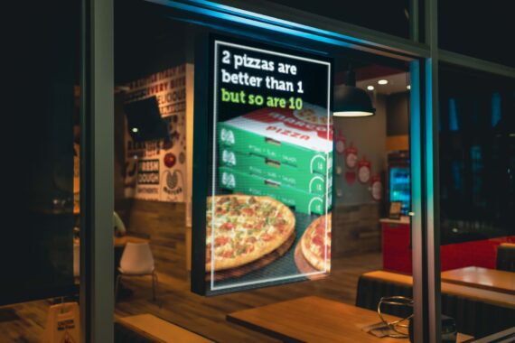 an image of an LED window poster with three stacks of pizza and the words "2 pizza are better than 1, but so are 10"